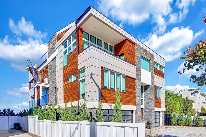 View of building exterior featuring a fenced front yard