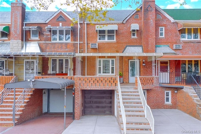 View of front of property with stairway, a chimney, and brick siding