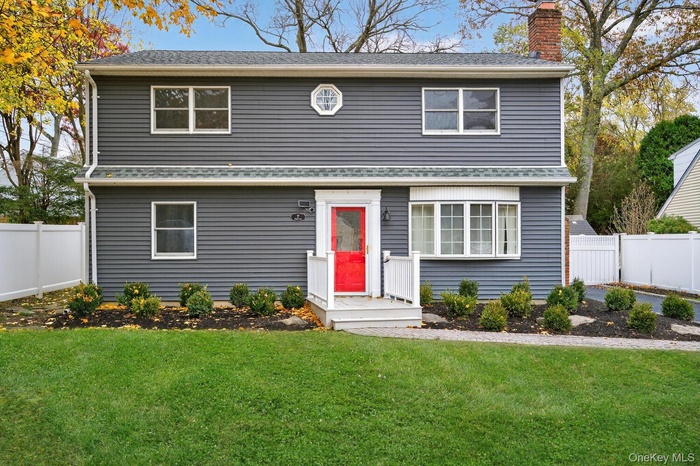 Traditional-style house with a chimney and roof with shingles