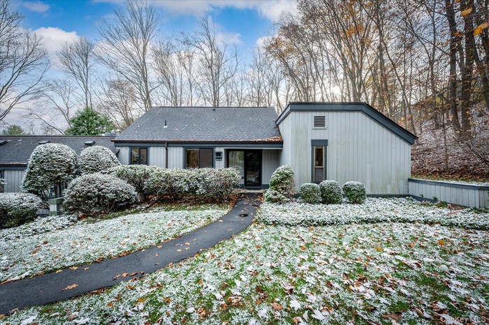 View of front of home with a shingled roof