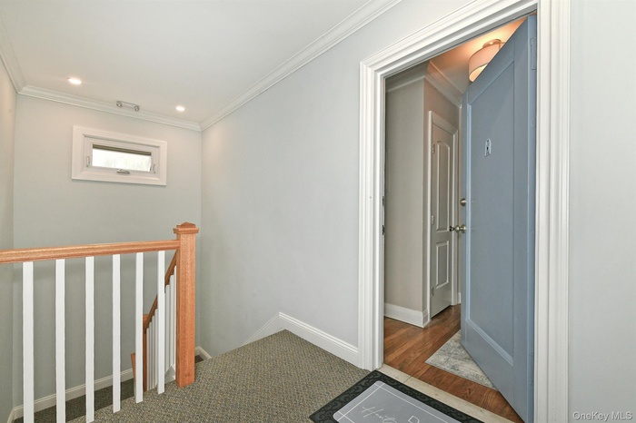 Hall featuring an upstairs landing, crown molding, recessed lighting, and carpet flooring