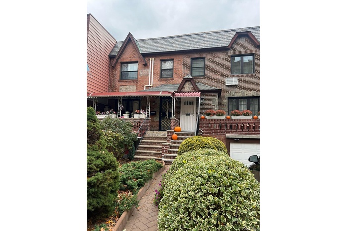 View of front facade featuring brick siding and covered porch