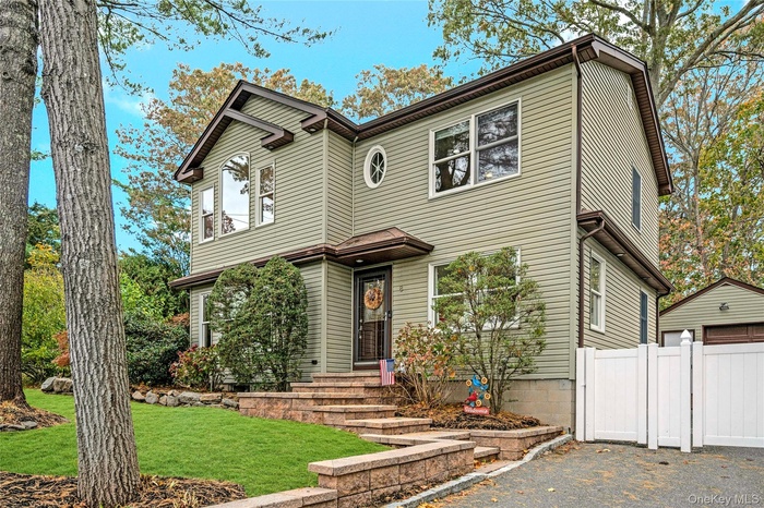 View of front of property featuring a detached garage