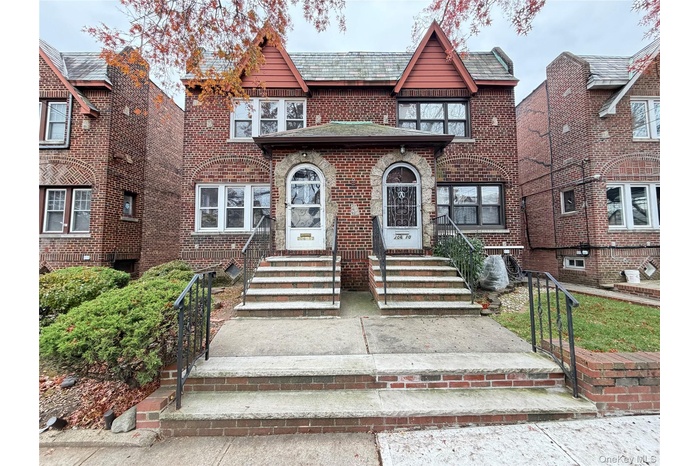 English style home featuring brick siding