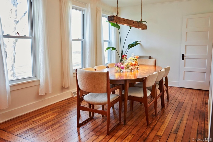 Dining room featuring wood-type flooring and ornamental molding