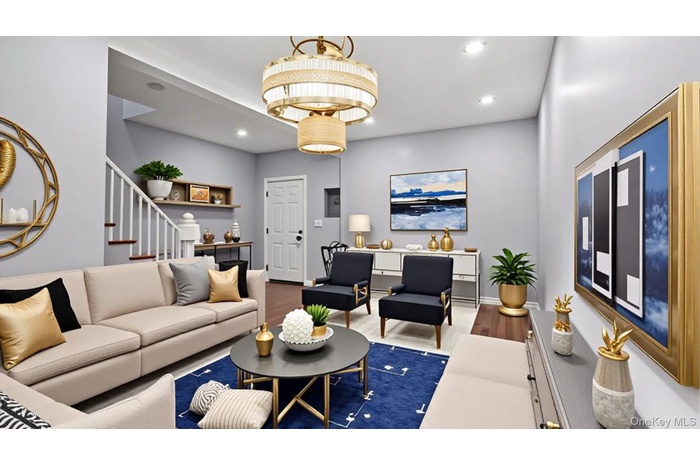 Living area featuring wood finished floors, recessed lighting, and stairs