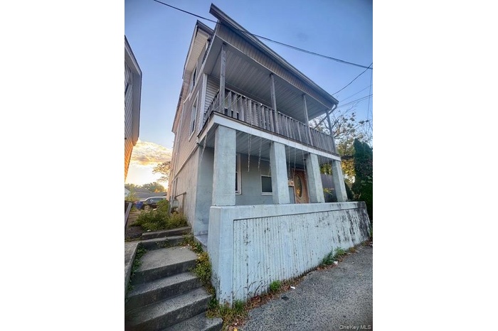 View of side of property featuring a balcony