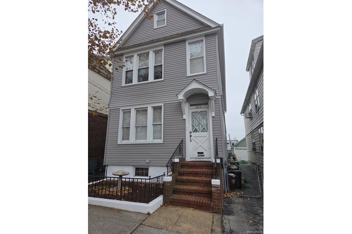 View of front of home with a fenced front yard and a gate