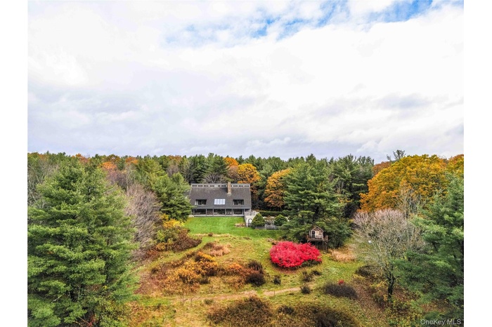 View of subject property with a forest