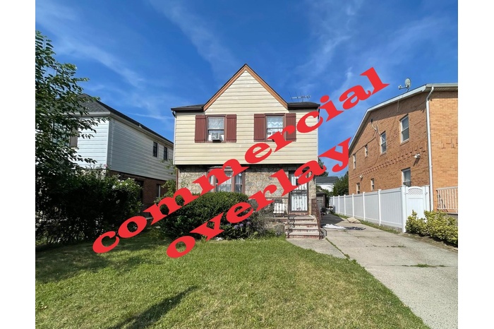 View of front of home featuring stone siding and driveway
