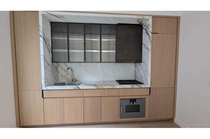 Kitchen featuring tasteful backsplash, wall oven, and black gas cooktop