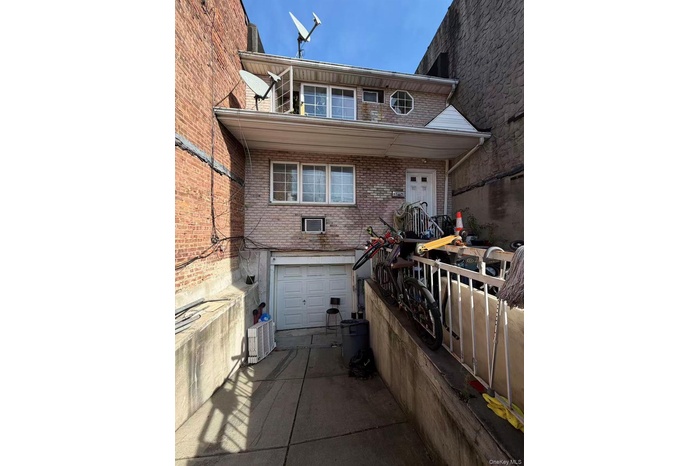 View of front facade with brick siding, a garage, and concrete driveway