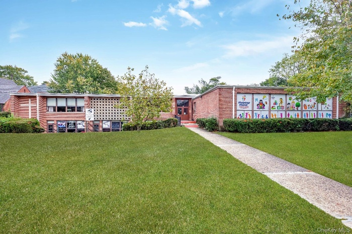 View of front of house with a front lawn and brick siding