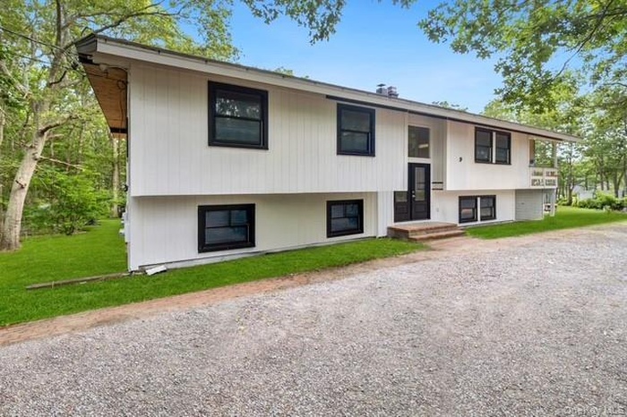 Split foyer home featuring a front yard