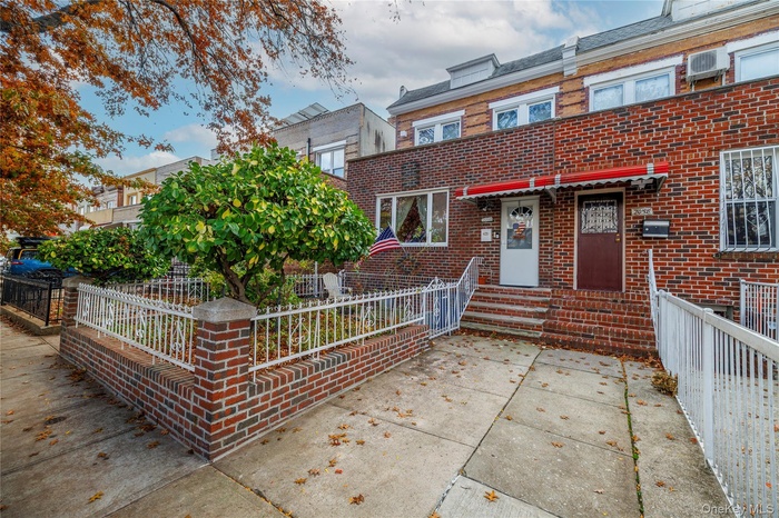 View of front of property featuring a fenced front yard and brick siding