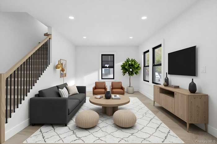 Living area featuring recessed lighting, light wood-style flooring, and stairway