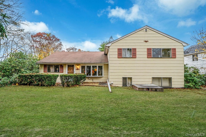 Rear view of property featuring a yard and a porch