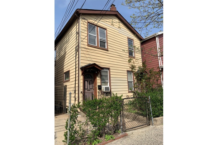 View of front of house featuring a gate and a chimney