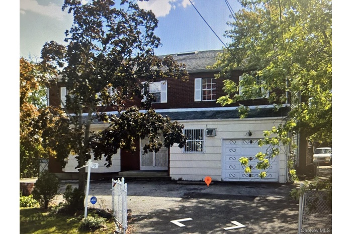 View of front facade featuring a garage