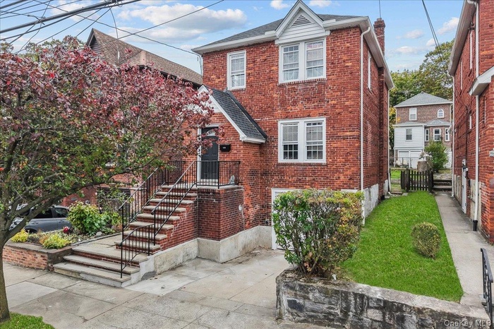 Traditional home with brick siding and roof with shingles