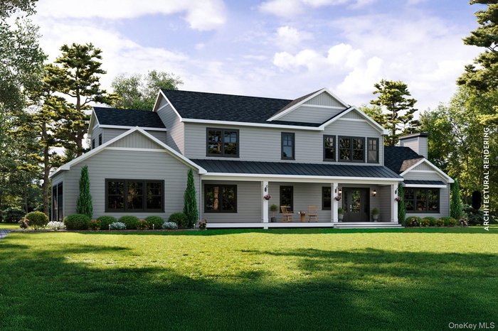 Modern farmhouse featuring covered porch, a front lawn, and roof with shingles