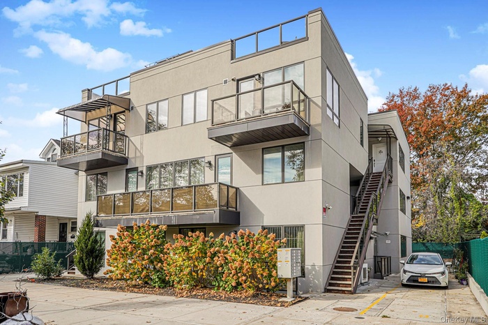 View of apartment building / complex featuring stairs