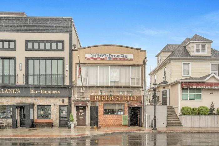 View of commercial property featuring stairs