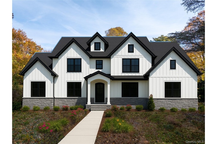 View of front facade with board and batten siding and stone siding
