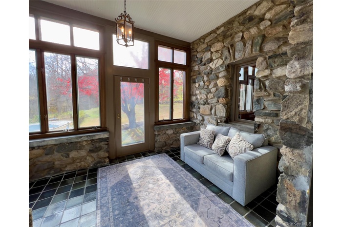 Stone surround sun room with chandelier