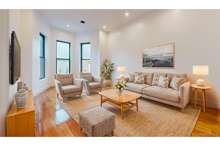 Living room featuring light wood-type flooring and recessed lighting