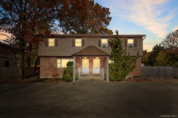 Colonial inspired home with brick siding