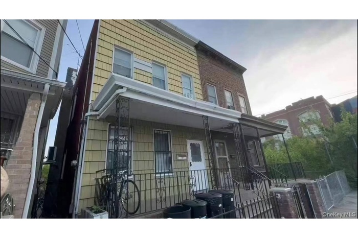 Multi unit property with a fenced front yard and central air condition unit