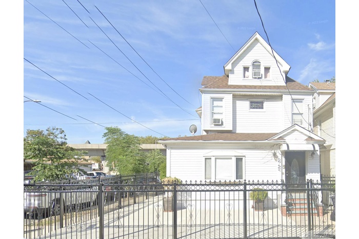 Victorian home with a fenced front yard, roof with shingles, and a gate