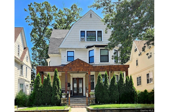 View of front of property with Large covered porch and Long Driveway