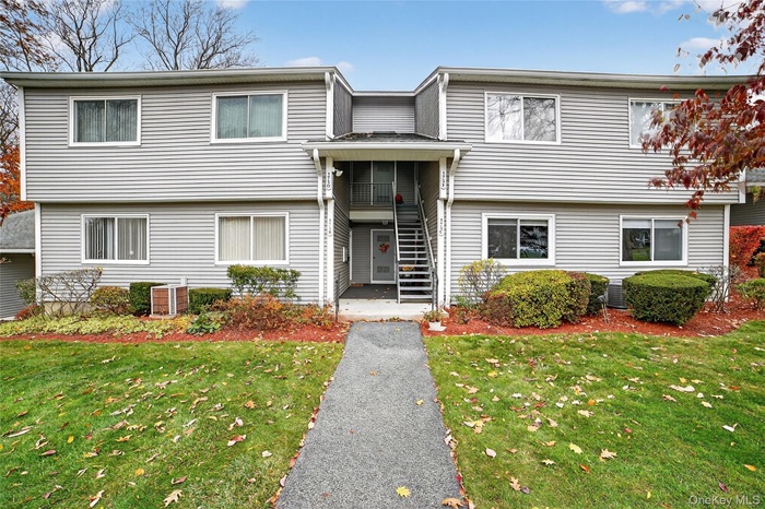 View of front of house featuring a front lawn and covered entryway