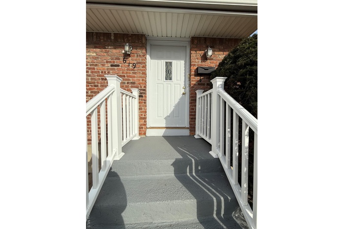 View of exterior entry with brick siding