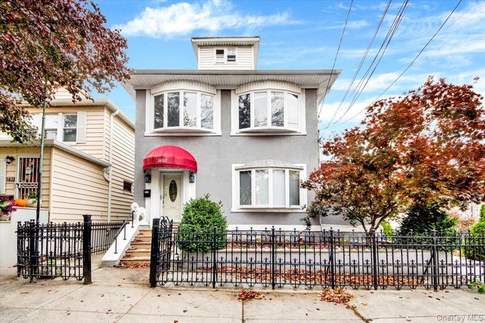 View of front of property featuring a fenced front yard and stucco siding