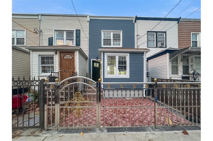 Traditional-style house with a fenced front yard and a gate