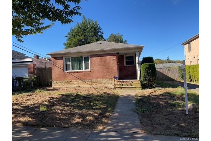 View of front of house featuring brick siding