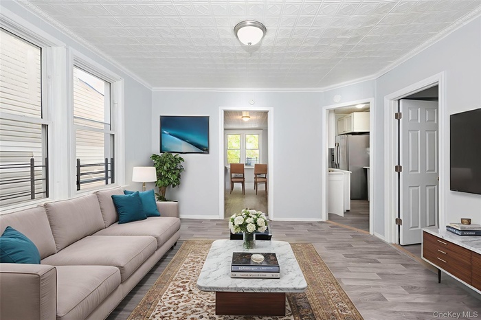 Living room featuring crown molding and wood finished floors
