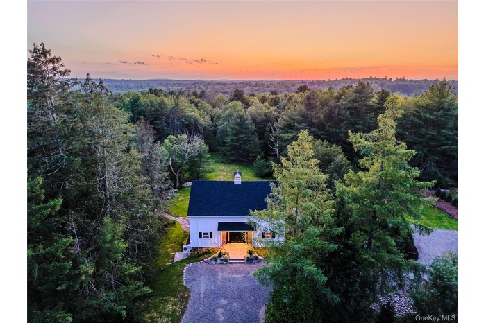 View of subject property with a forest