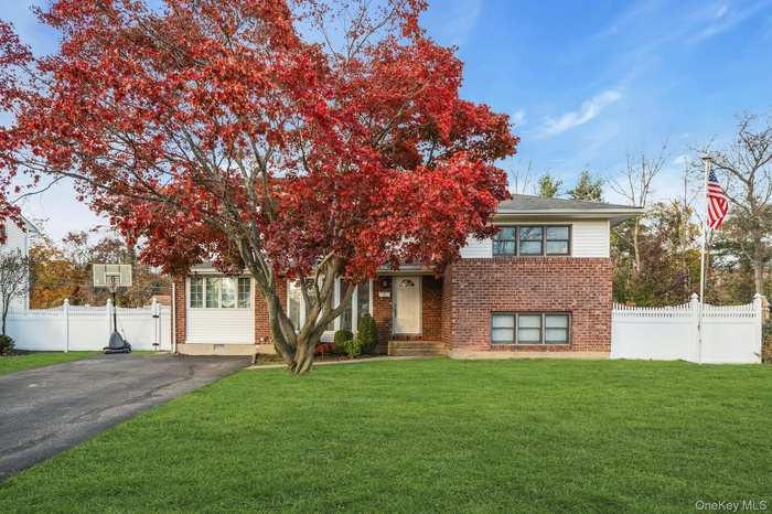 Obstructed view of property with brick siding