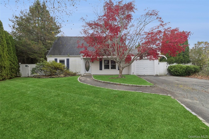 View of front of property with driveway and a garage