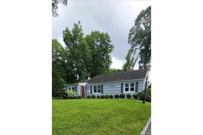Ranch-style home featuring a front yard