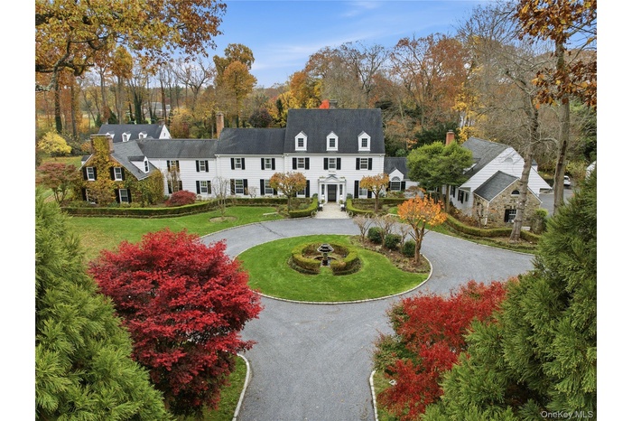 Aerial view of estate and surrounding area with a tree filled landscape