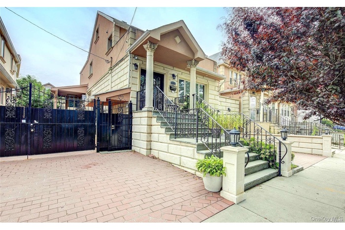 View of front of property with stucco siding and a gate