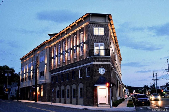 View of property at dusk