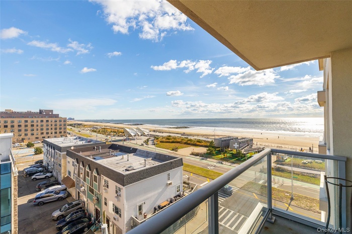 Balcony with view of water and beach