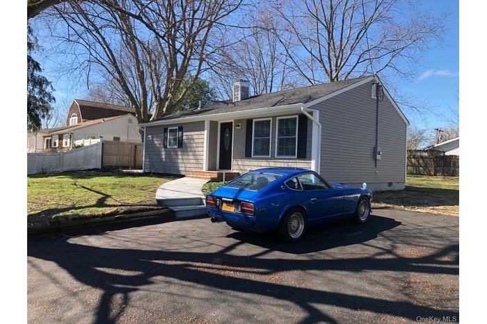 View of front of property with a chimney and a shingled roof