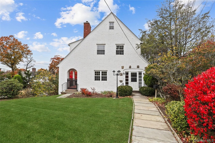 Rear view of house with a yard and a chimney